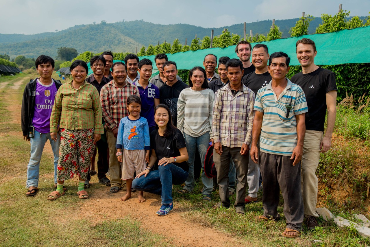 Grower partners and the Fair Farms team standing together at the edge of a pepper field